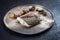 Gourmet fried European skrei cod fish filet with algae and vegetable crisps on a modern design plate