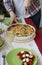 A gourmet lunch: spinach pie with cheese, a bowl of fruits, a salad and wine