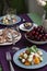 A gourmet lunch for two: a salad, fresh cherries and various appetizers