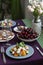 A gourmet lunch for two: a salad, fresh cherries and various appetizers