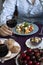 A gourmet lunch for two: a salad, fresh cherries and various appetizers