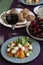 A gourmet lunch for two: a salad, fresh cherries and various appetizers
