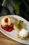 Gourmet mango ice cream with redcurrant sauce dessert on plate