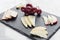 Gourmet mixed cheese board tapas starter with apple and grapes