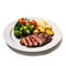 A gourmet plate with delicious looking beef and a side of vegetables and sauce. White isolated.