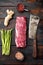 Gourmet portion of raw fresh marbled beef fillet , with old butcher cleaver knife, on old dark  wooden table background, top view