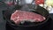 Gourmet rib steak simmering in a cast iron skillet, 4k