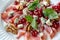 Gourmet salad with prosciutto, pomegranate, blue cheese, and walnuts