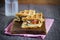 Gourmet sandwich of waffles, prosciutto, cheese and mushrooms