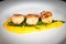 Gourmet seafood dish of scallops and asparagus on a white plate
