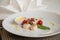 Gourmet seared scallops with garnishes.