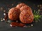 Gourmet Sesame Seed Coated Meatballs with Herbs and Balsamic Glaze on a Dark Elegant Background Culinary Presentation