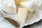 Gourmet spicy Camembert cheese, brie on white paper background with cheese knife. Spicy appetizer for gourmets. Selective focus