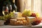 Gourmet Starters, Cheese Selection, Grapes, and White Wine for Elegant Culinary Delight