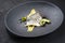 Gourmet style fried gilthead fish filet with caviar, avocado slices and mustard mango creme on a modern design plate