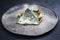 Gourmet style fried gilthead fish filet with sliced dumpling, glasswort and algae on a rustic modern design plate