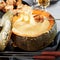 Gourmet Swiss cheese fondue served in a pumpkin