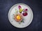 Gourmet tartar raw from beef fillet with yellow of the egg and vegetable on modern Nordic design plate