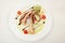 Gourmet tasty octopus with lemon and cherry tomatoes