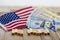 Government Shutdown USA concept with American flag and money bills on white background and wooden board