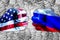 Governments conflict concept. Male fists colored in USA and Russian flags against the background of silhouettes of heads of people