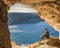 Gozo island Malta, young man in a cave looking out over the ocean