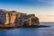 Gozo, Malta - The famous Fungus rock on the island of Gozo at Dwejra bay at sunset