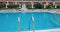 Grab bars ladder in the blue swimming pool