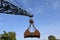 Grab dredger excavator standing as silhouette at blue sky