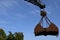 Grab dredger excavator standing as silhouette at blue sky