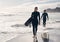 Grab your surfboard and let the adventure begin. a young couple out surfing together at the beach.