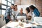 Grab your team and get it done. a group of colleagues using a laptop together in a modern office.