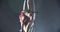 Graceful aerial gymnastics performance in a hoop by a brunette woman, 4k