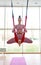 Graceful athlete in the lotus position performs yoga stretching exercises in hammock