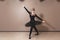 Graceful ballerina in black swan dress. Young ballet dancer practicing before performance in black tutu, classical dance studio,