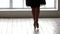 Graceful ballerina legs in pointe shoes at the dance studio.