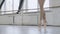 Graceful ballerina legs in pointe shoes. girl dancing in the old dance hall slow motion
