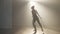 Graceful ballerina rehearsing ballroom movements in backlit fog. Wide shot of slim confident professional Caucasian