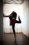 Graceful ballerina silhouette in ballet pose. Gorgeous ballet dancer performing, on pointes. Ballerina making her exercises