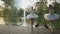 Graceful ballerinas dancing at the background with swans in park