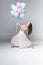 Graceful, beautiful ballerina dancing with festive balloons