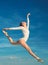 Graceful beauty. Concert performance dance. Young ballerina jumping on blue sky. Classic dance style. Cute ballet dancer