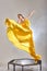 graceful charming woman with yellow Flying Fluttering Fabric