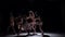 Graceful contemporary dance of five dancers in white clothes on black, shadow, slow motion