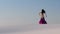 Graceful dancer against the sky dancing belly dance in a brilliant outfit