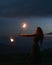 Graceful elegant red haired female fireshow performer