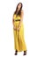 Graceful feminine fashion model in yellow dress posing at camera