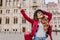Graceful girl in trendy casual attire enjoying european travel in weekend. Outdoor photo of blissful young woman in red