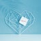 Graceful openwork heart on a pastel blue background. Minimalism. Concept Symbol of love and Valentine`s Day. Home Decor