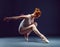 Graceful slender ballerina dancing in studio